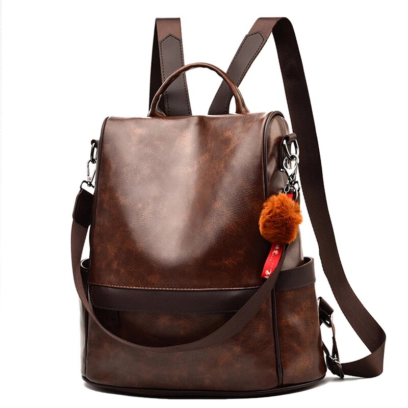 Mochila feminina de couro PU marrom com detalhes em pompom e alças ajustáveis