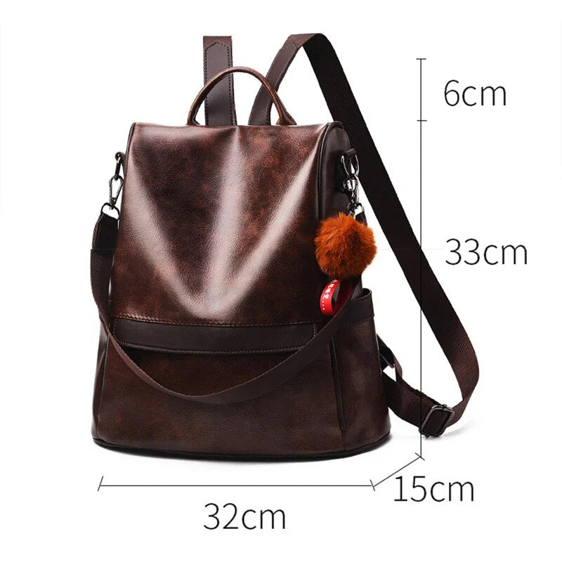Mochila feminina de couro PU marrom com design elegante e detalhe de pompom