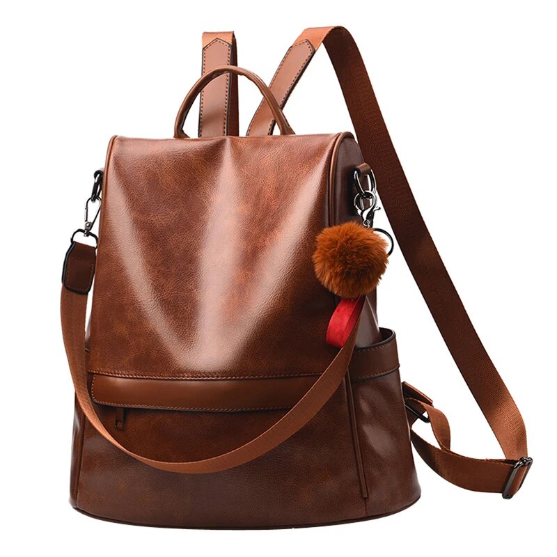 Mochila feminina de couro PU marrom com detalhe de pompom e alças ajustáveis