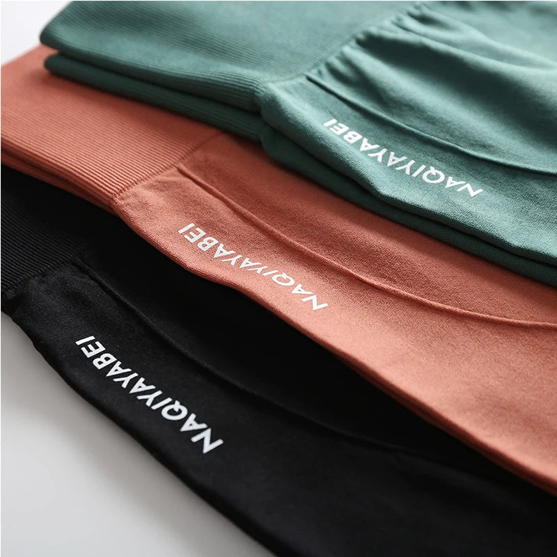 Conjunto de shorts sem costura feminino da NOENNAME_NULL em cores verde, laranja e preto