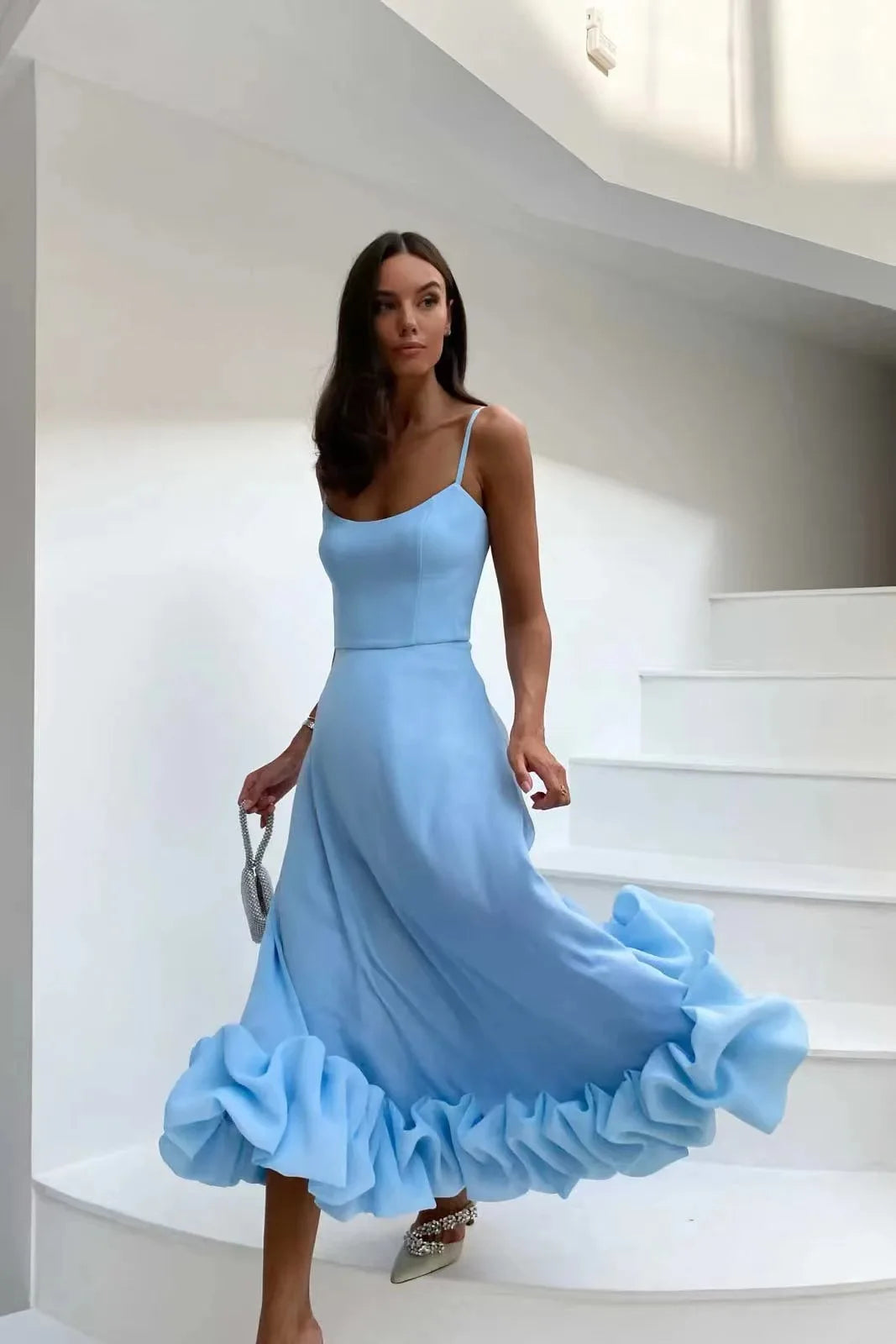 Vestido feminino elegante em azul com detalhes de babados e alças finas, perfeito para ocasiões especiais