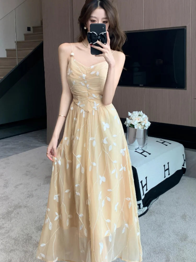 Vestido sem costas elegante da PMWRUN em tom amarelo com detalhes de flores brancas